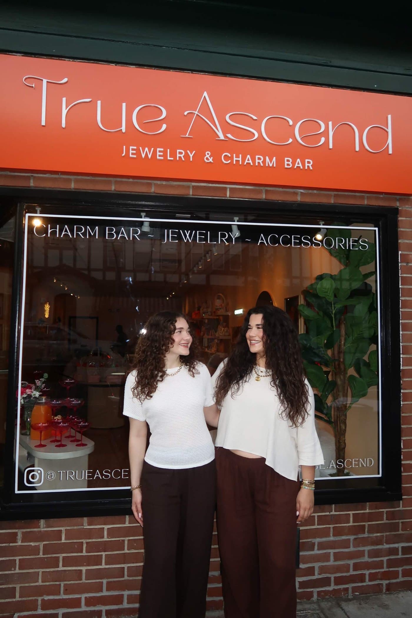 Bilana and Diypse standing outside the True Ascend jewelry and charm bar in Ridgewood, New Jersey